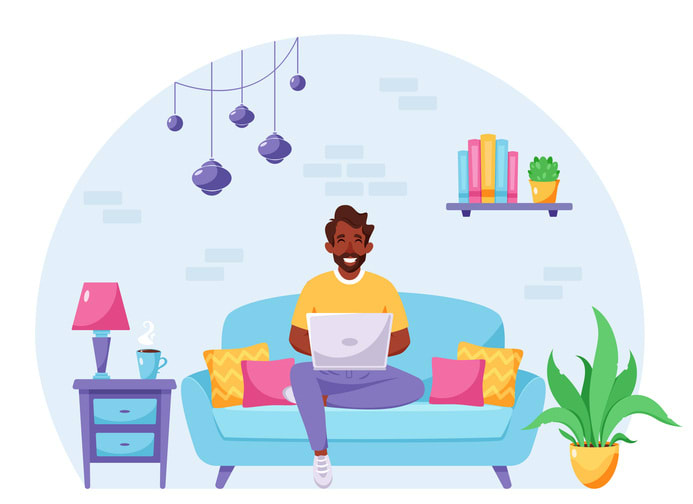 Black man sitting on a sofa and working on laptop