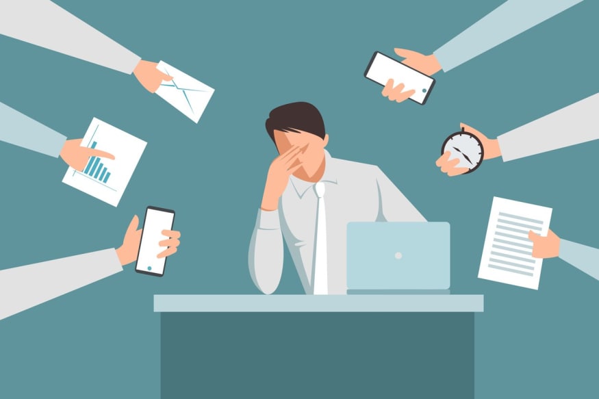 exhausted executive in middle of multiple tasks